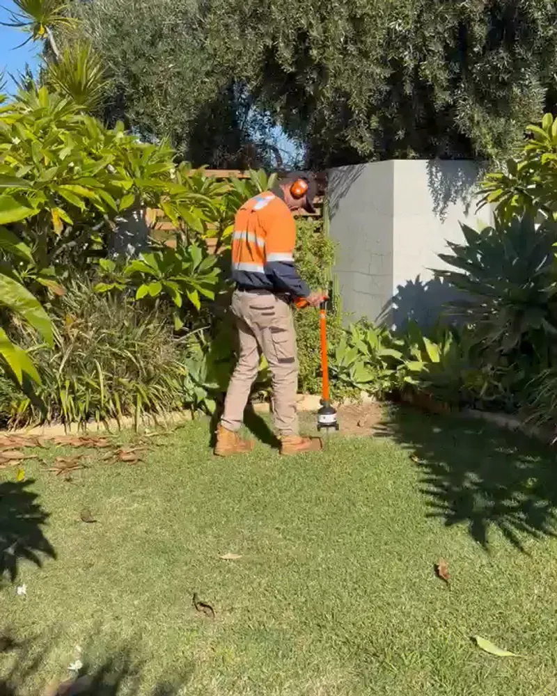 Leak detection technician sweeping a Perth lawn with an acoustic ground microphone