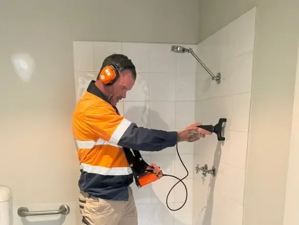 Leak detection technician locating a hidden water leak in a Perth home