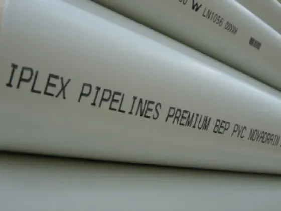 Stacked Iplex Pipelines PVC pipes with the manufacturer branding printed along each length